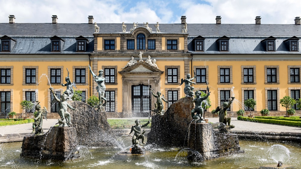 a large building with a fountain in front of it
