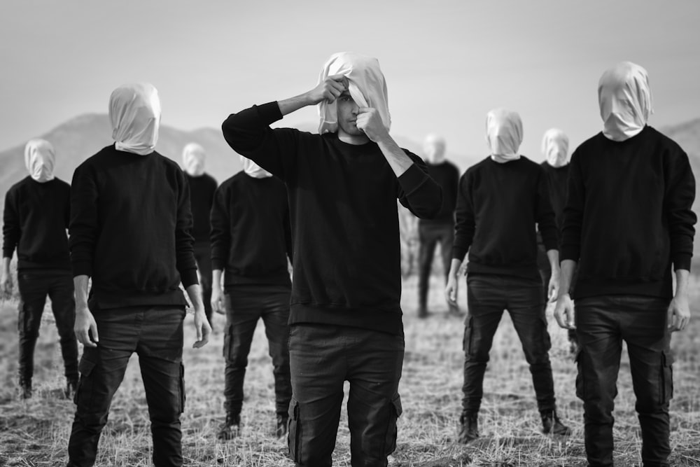 a group of people standing in a field