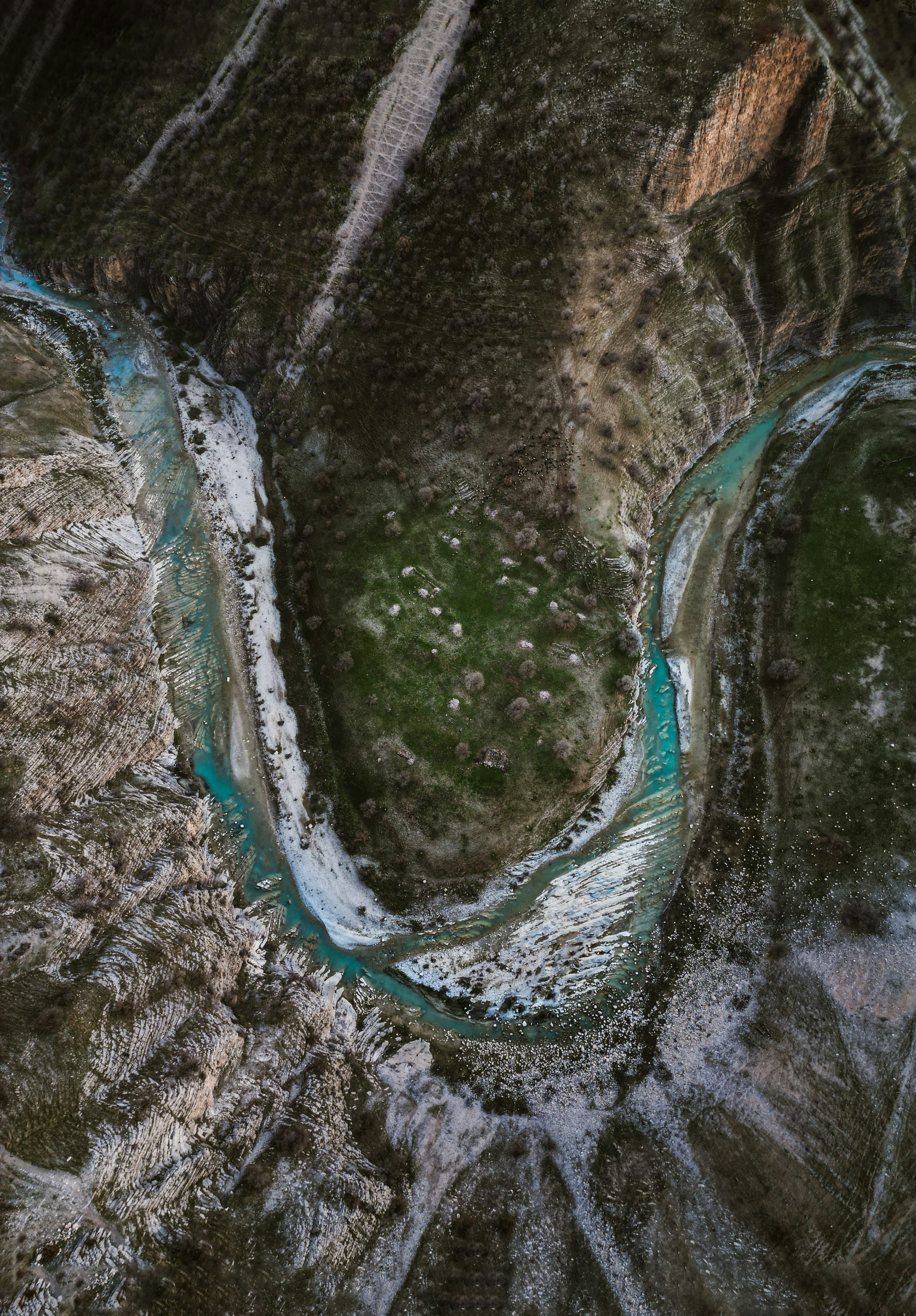 a river flowing through a lush green valley