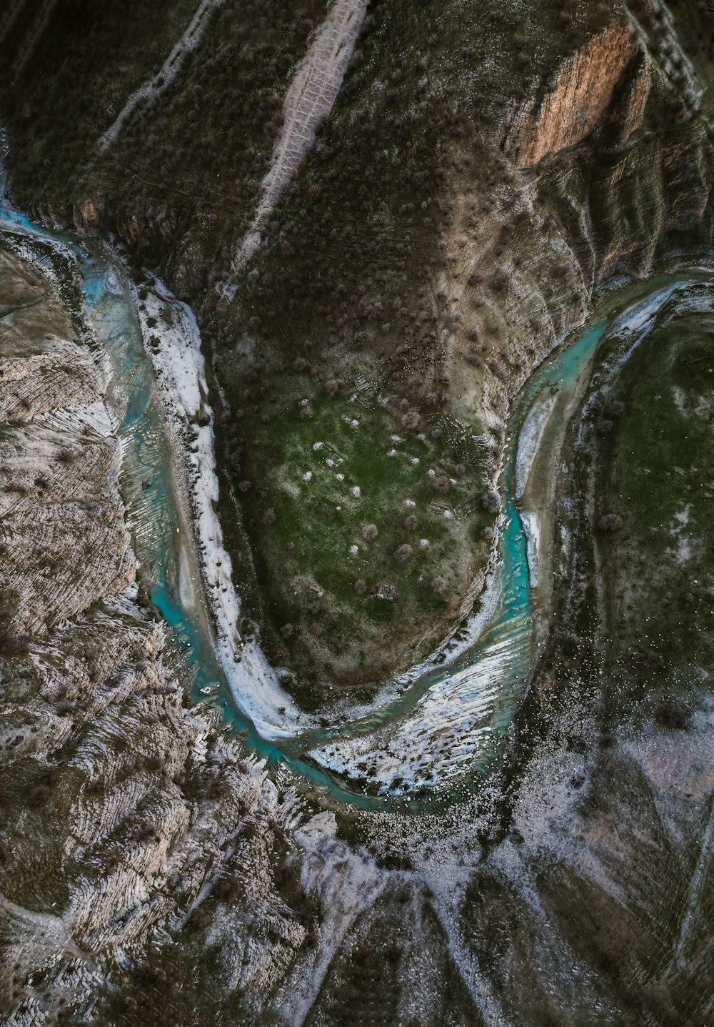 a river flowing through a lush green valley