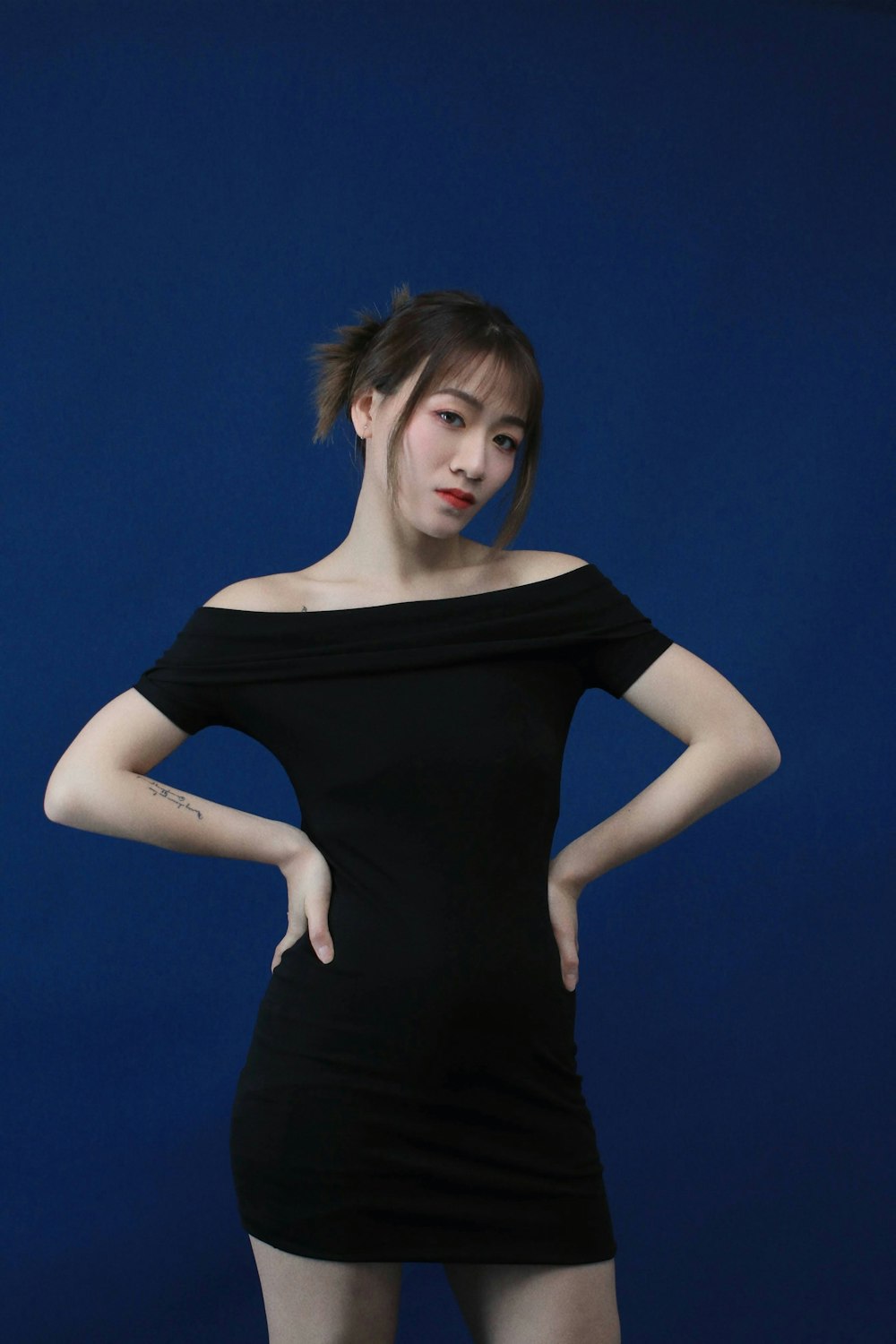 a woman in a black dress posing for a picture