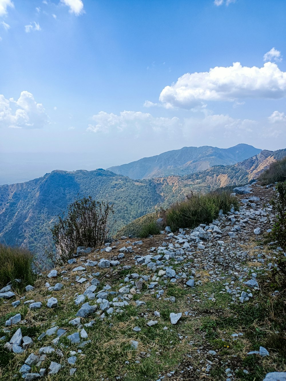 a view of the mountains from the top of a hill