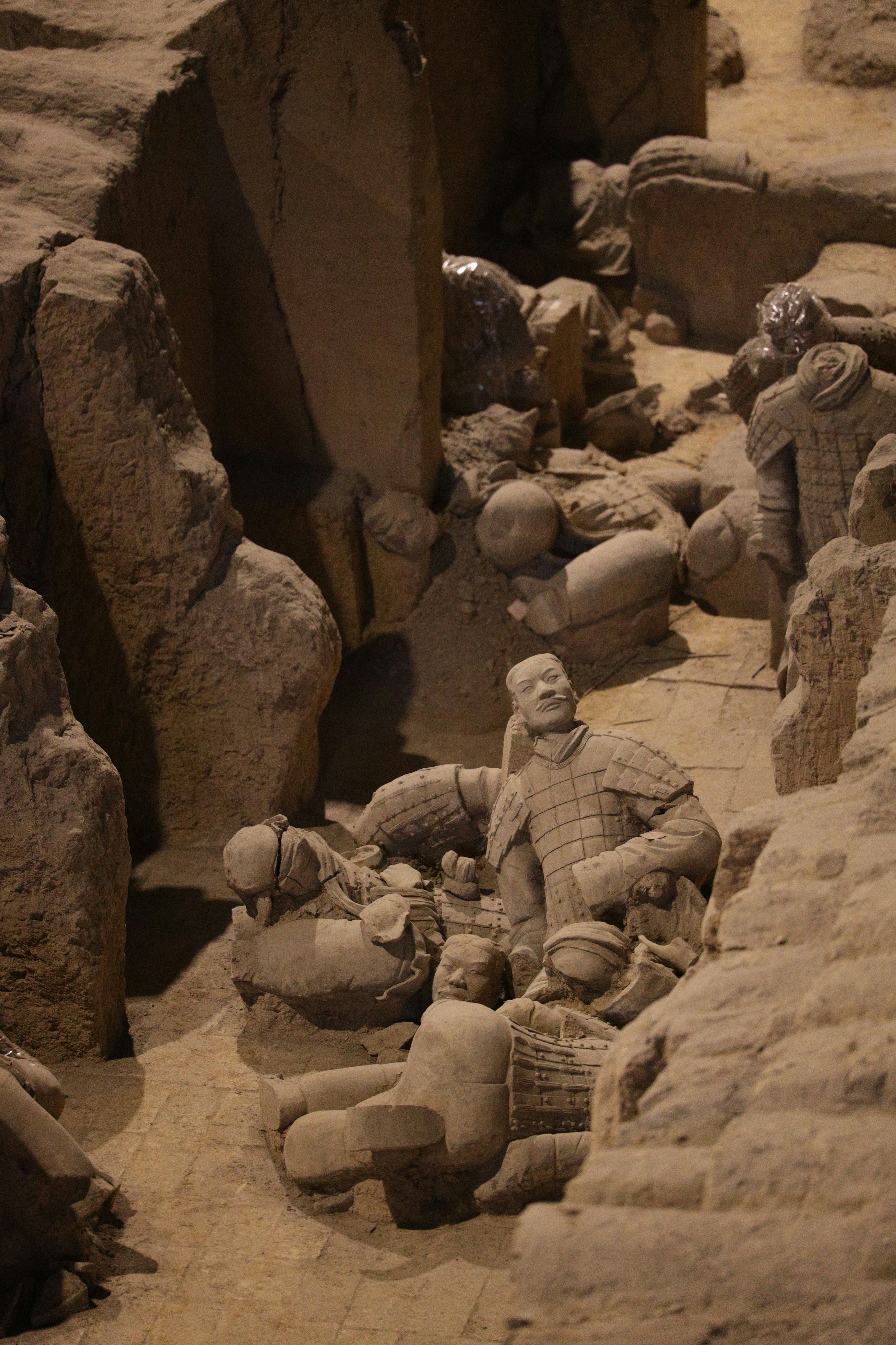 a statue of a man sitting in a cave