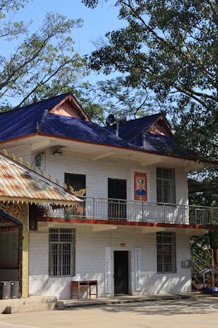 a large white building with a blue roof