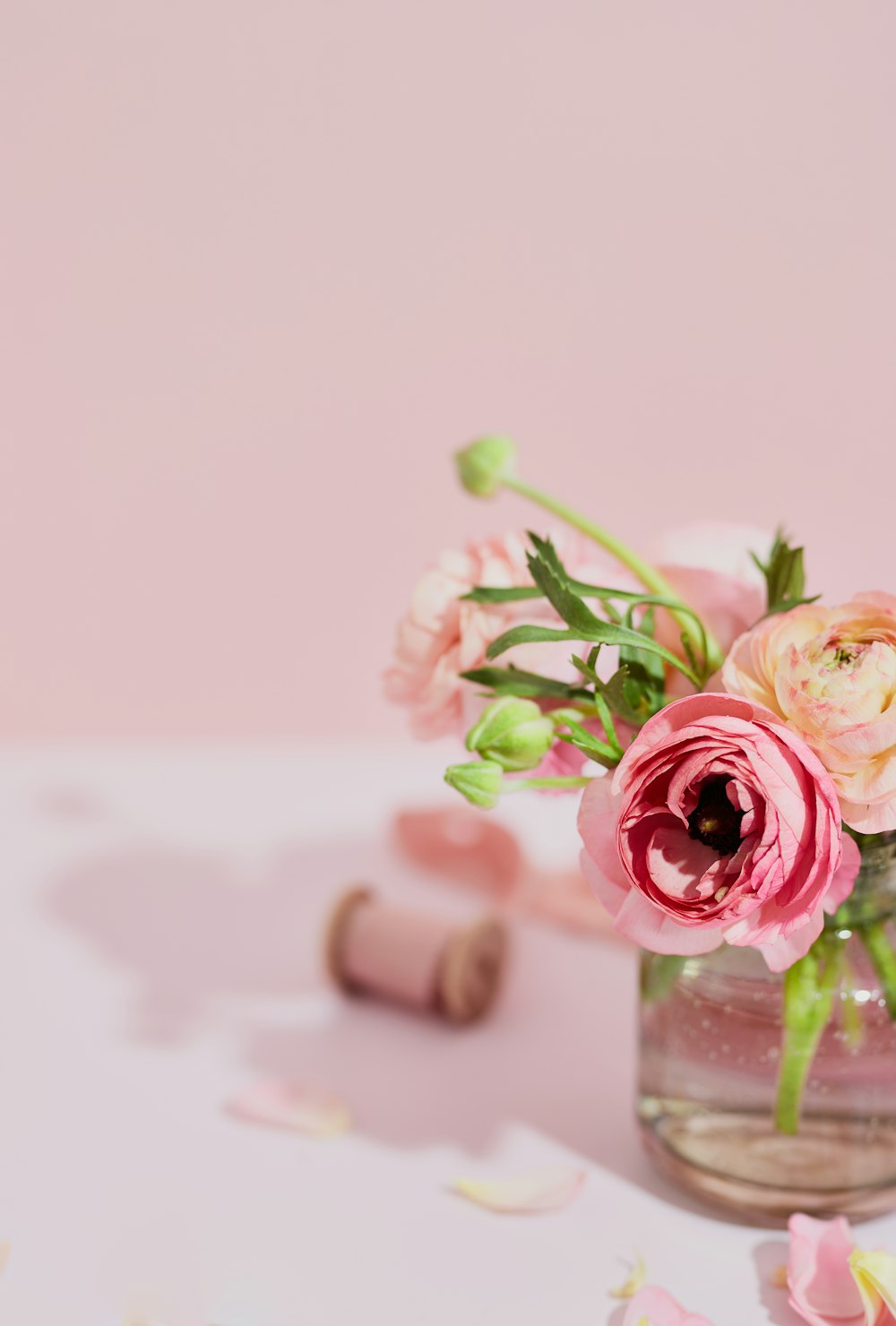 a vase filled with pink flowers on top of a table