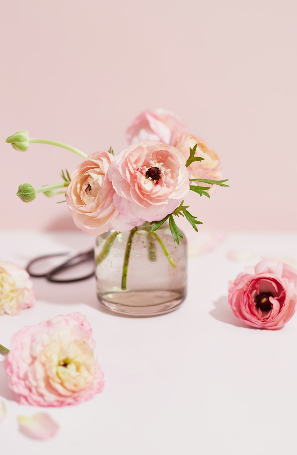 a vase filled with pink flowers on top of a table