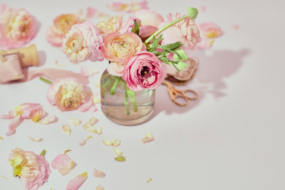 a vase filled with pink flowers on top of a table