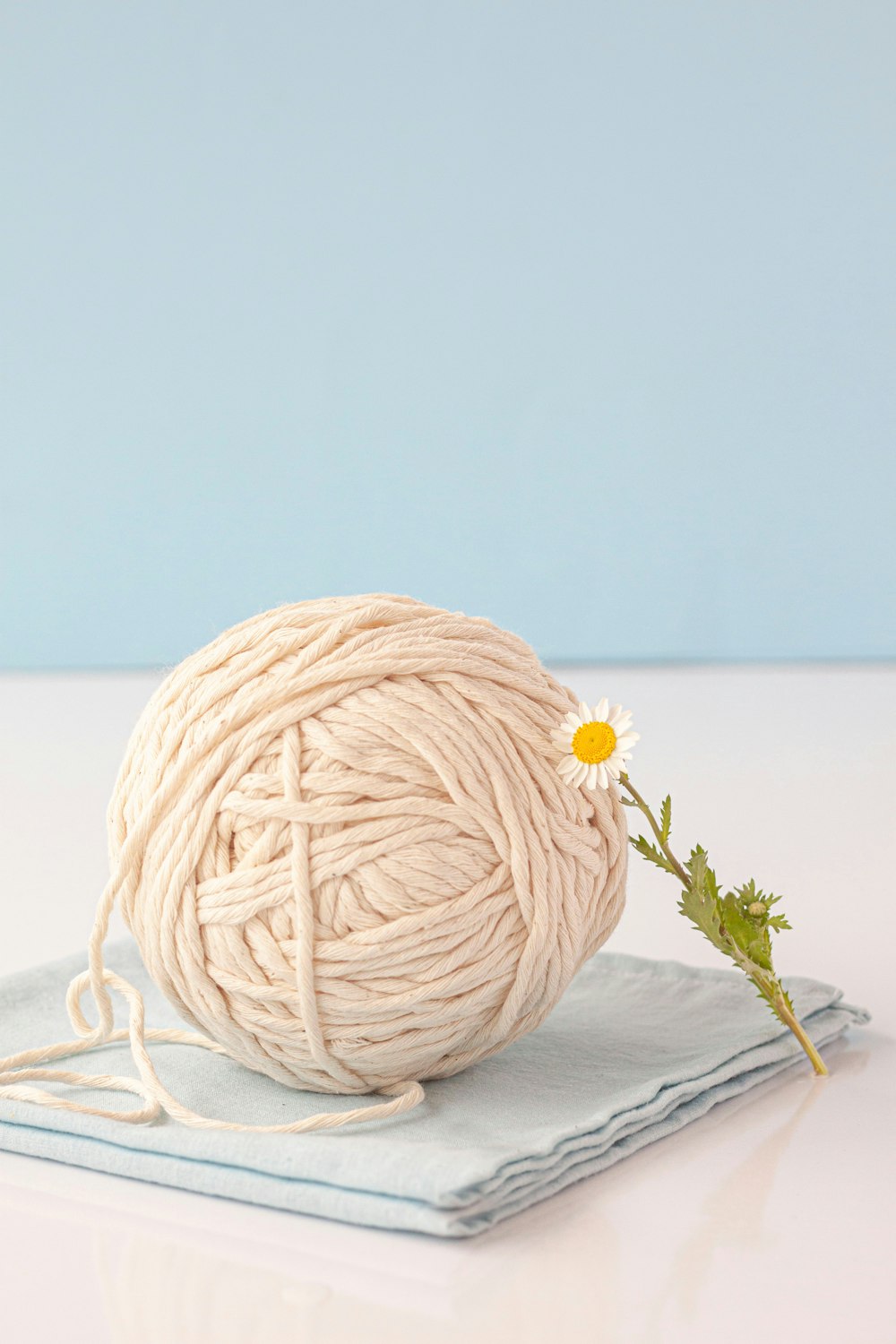 a ball of yarn sitting on top of a napkin