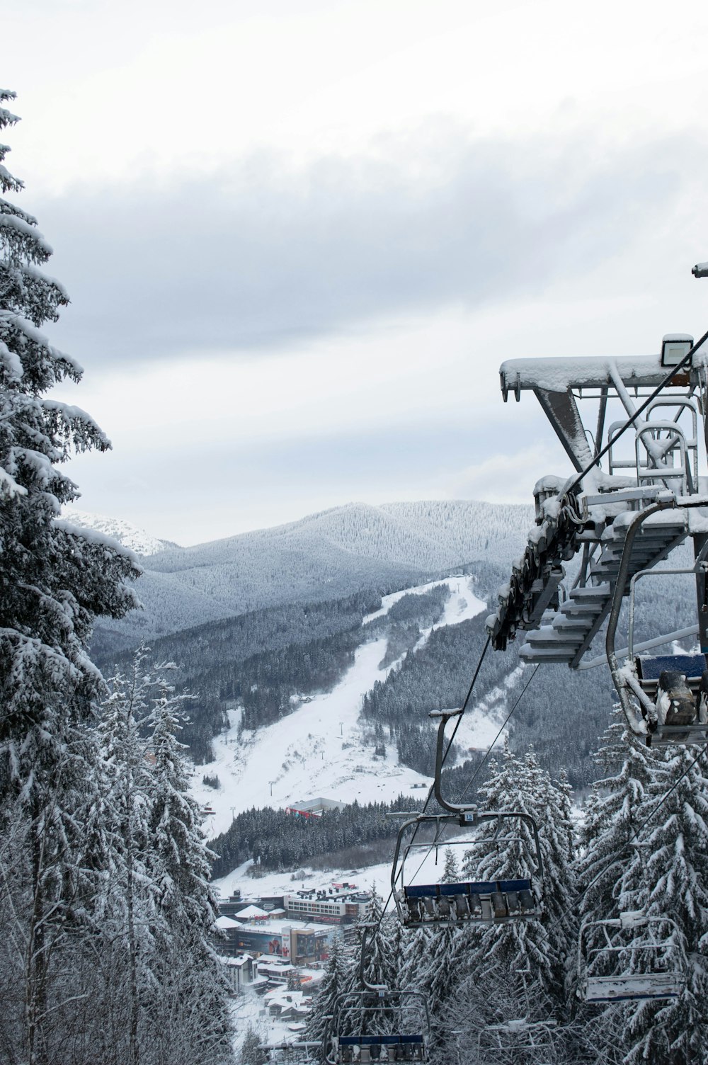 a ski lift going up a snowy mountain