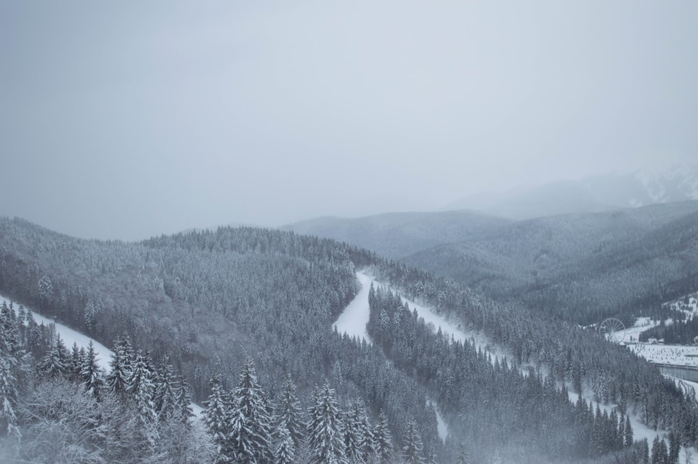 a snow covered mountain with a ski slope in the foreground