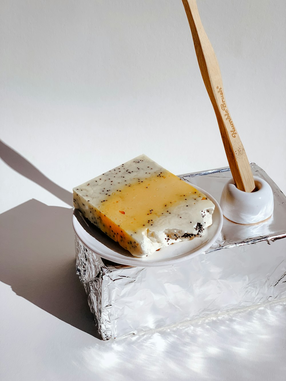 a piece of cheese sitting on top of a white plate