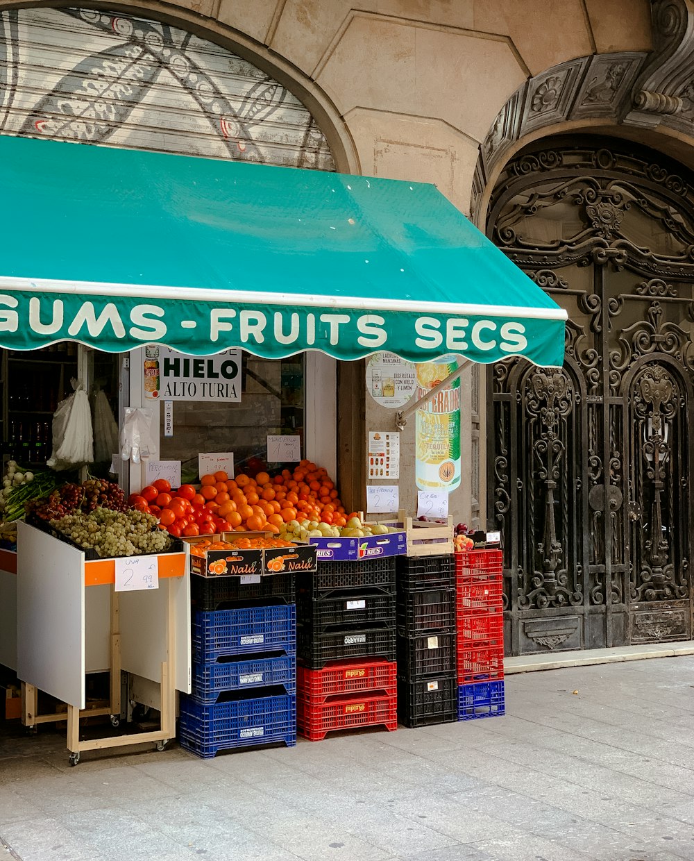 a fruit stand on the side of the street