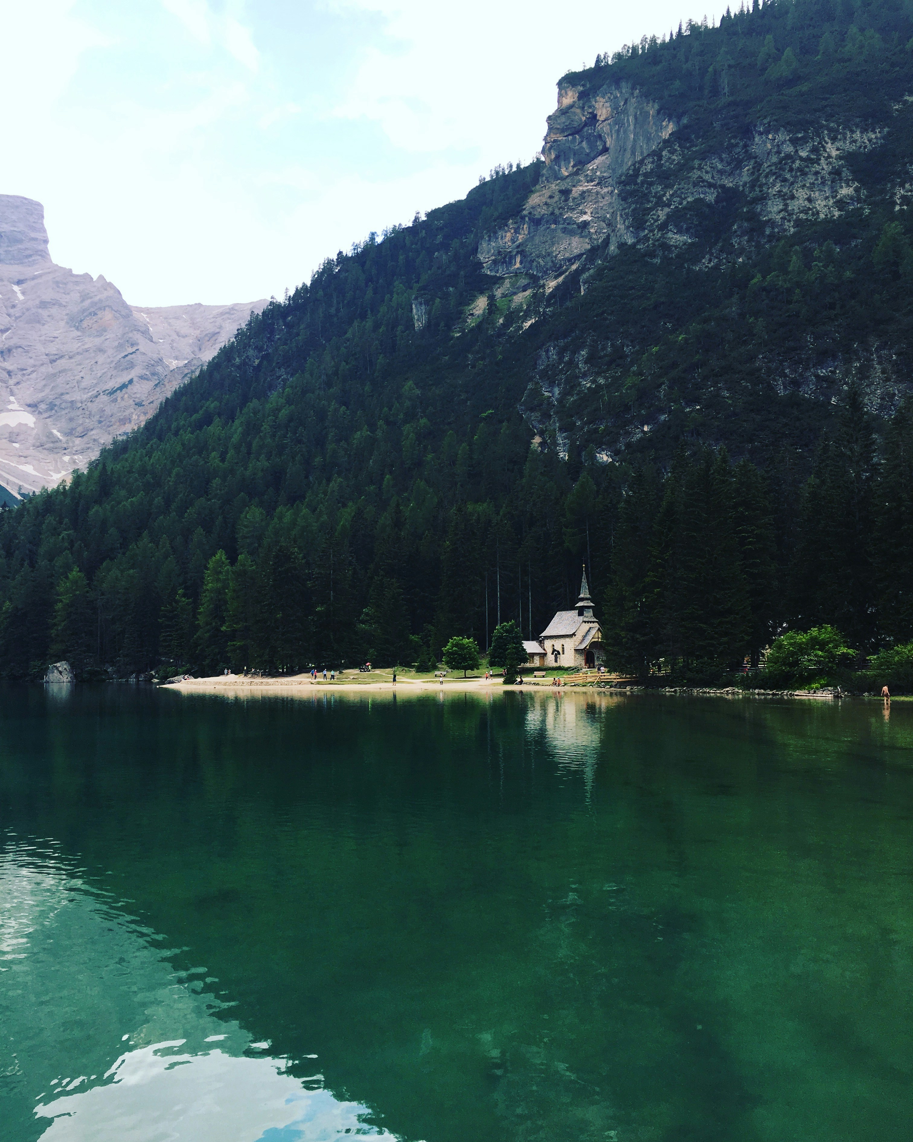 a house on the shore of a mountain lake