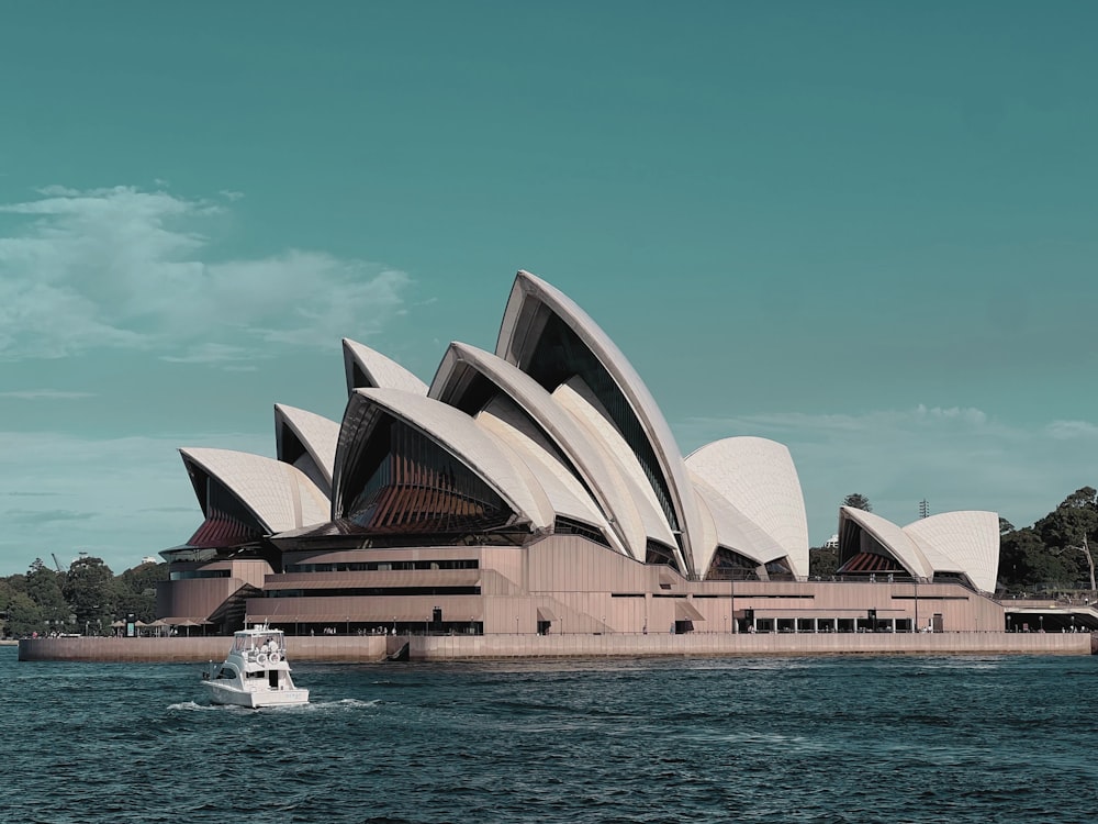 a boat in a body of water near a large building