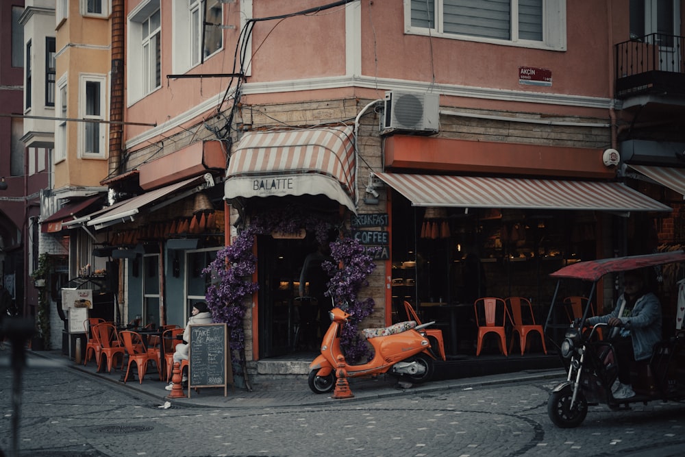 an orange scooter parked in front of a restaurant