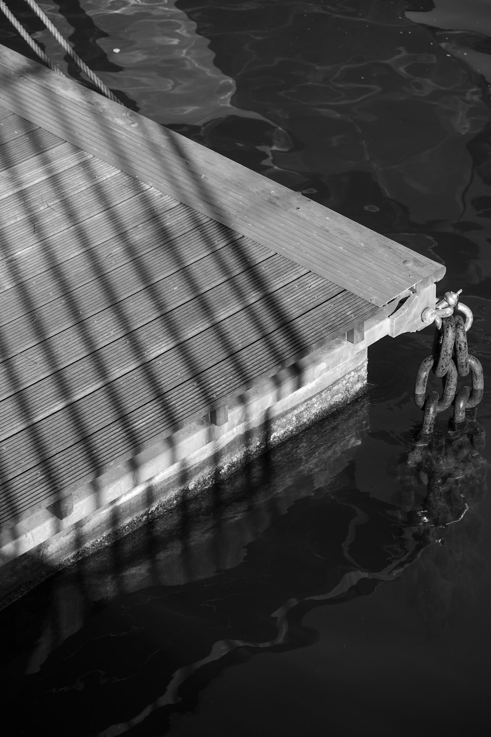 a chain is attached to a dock in the water