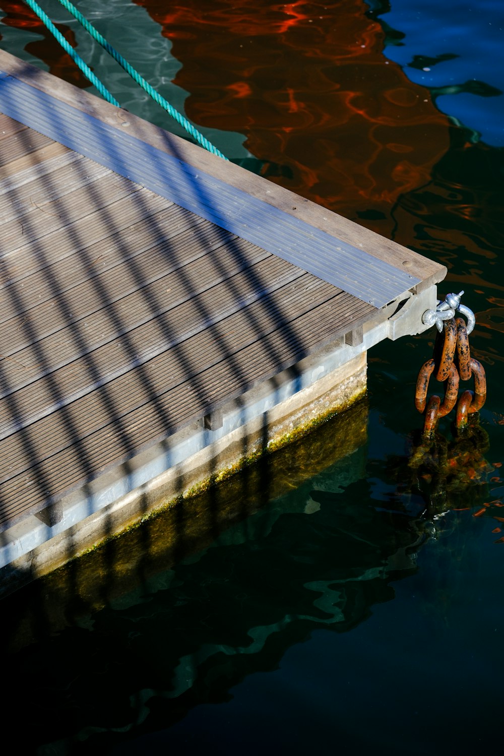 a boat dock with a chain hanging from it's side
