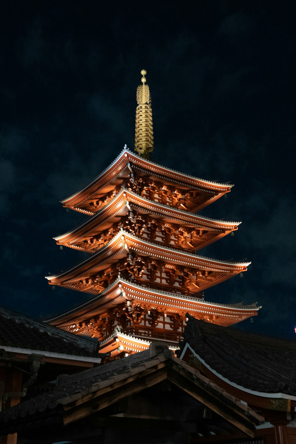 a tall building with a tower lit up at night