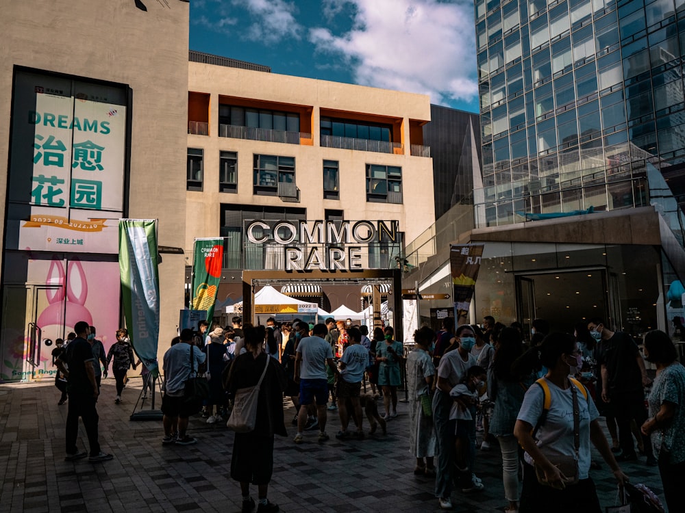 a crowd of people standing around a building