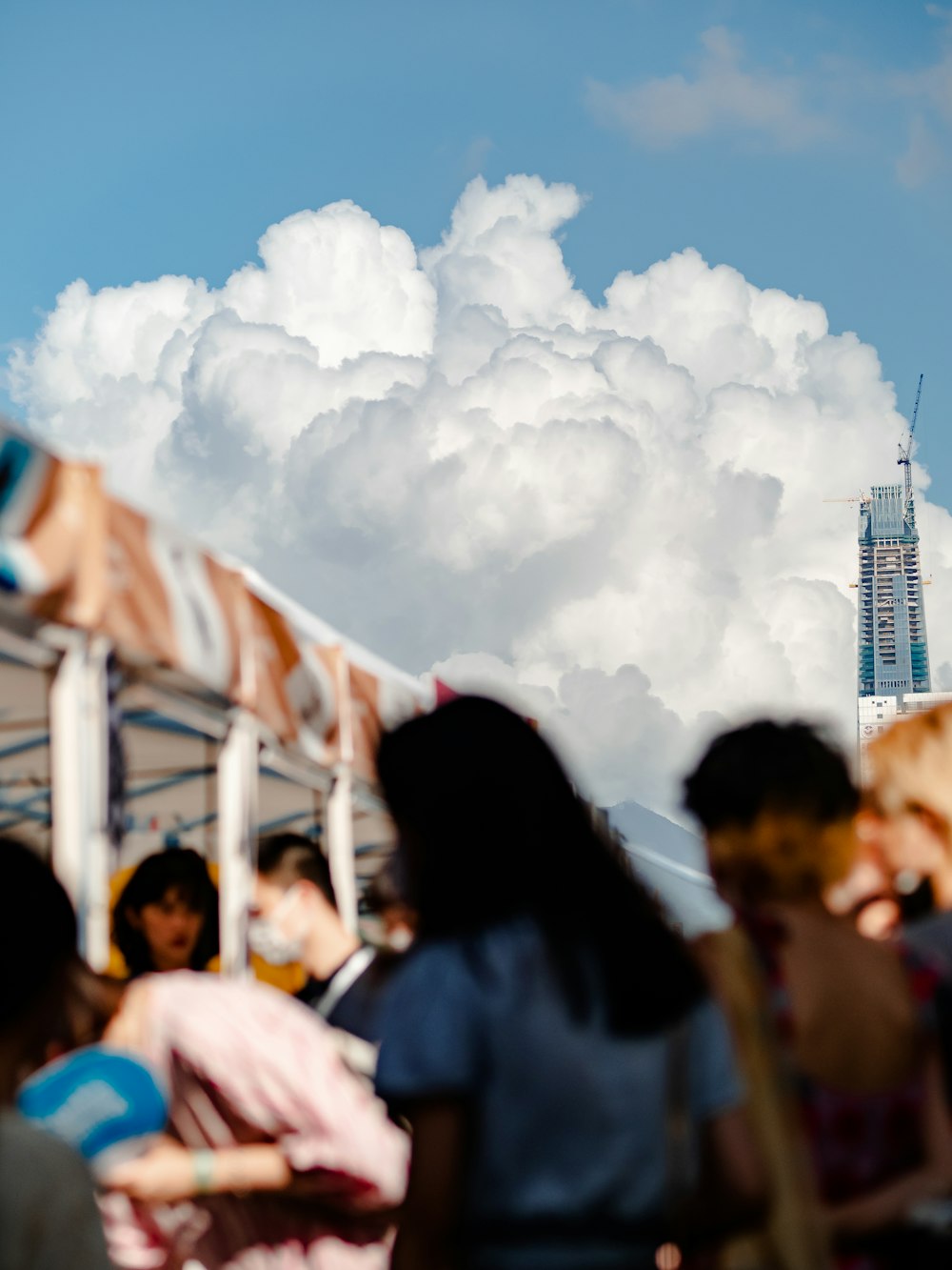 a group of people standing under a cloudy sky