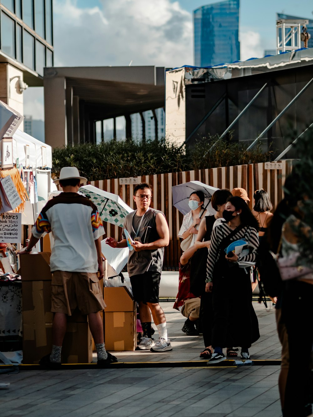 a group of people standing around a cardboard box