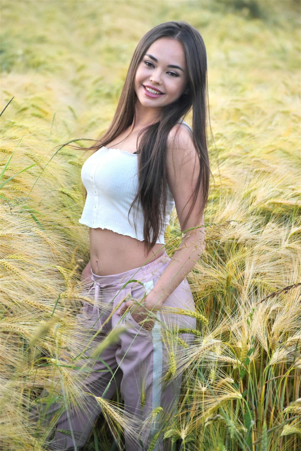 a woman standing in a field of tall grass