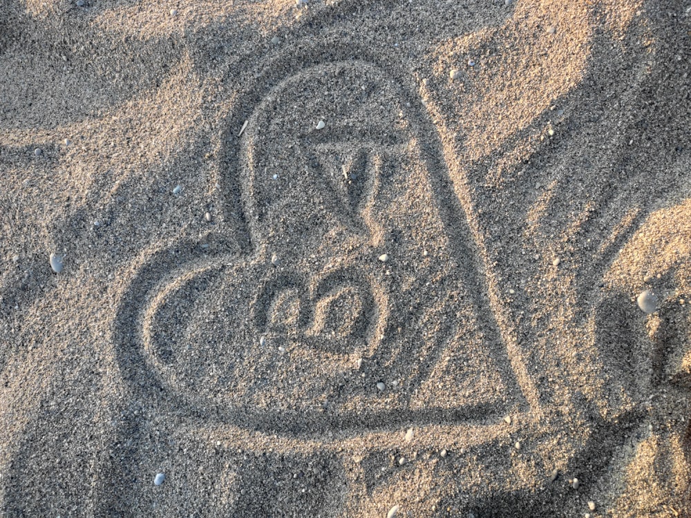 a heart drawn in the sand on a beach