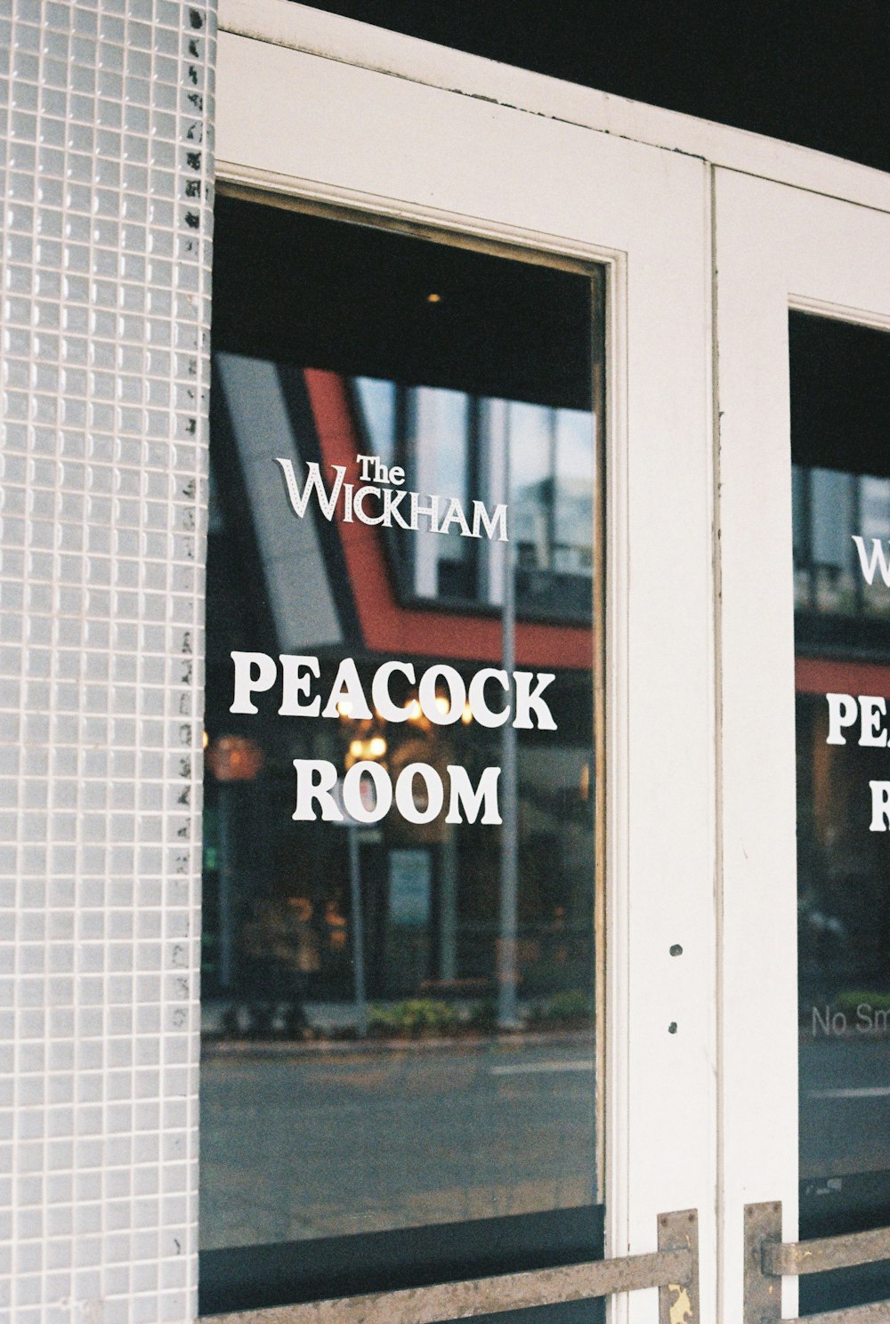 a store front window with the words peacock room on it
