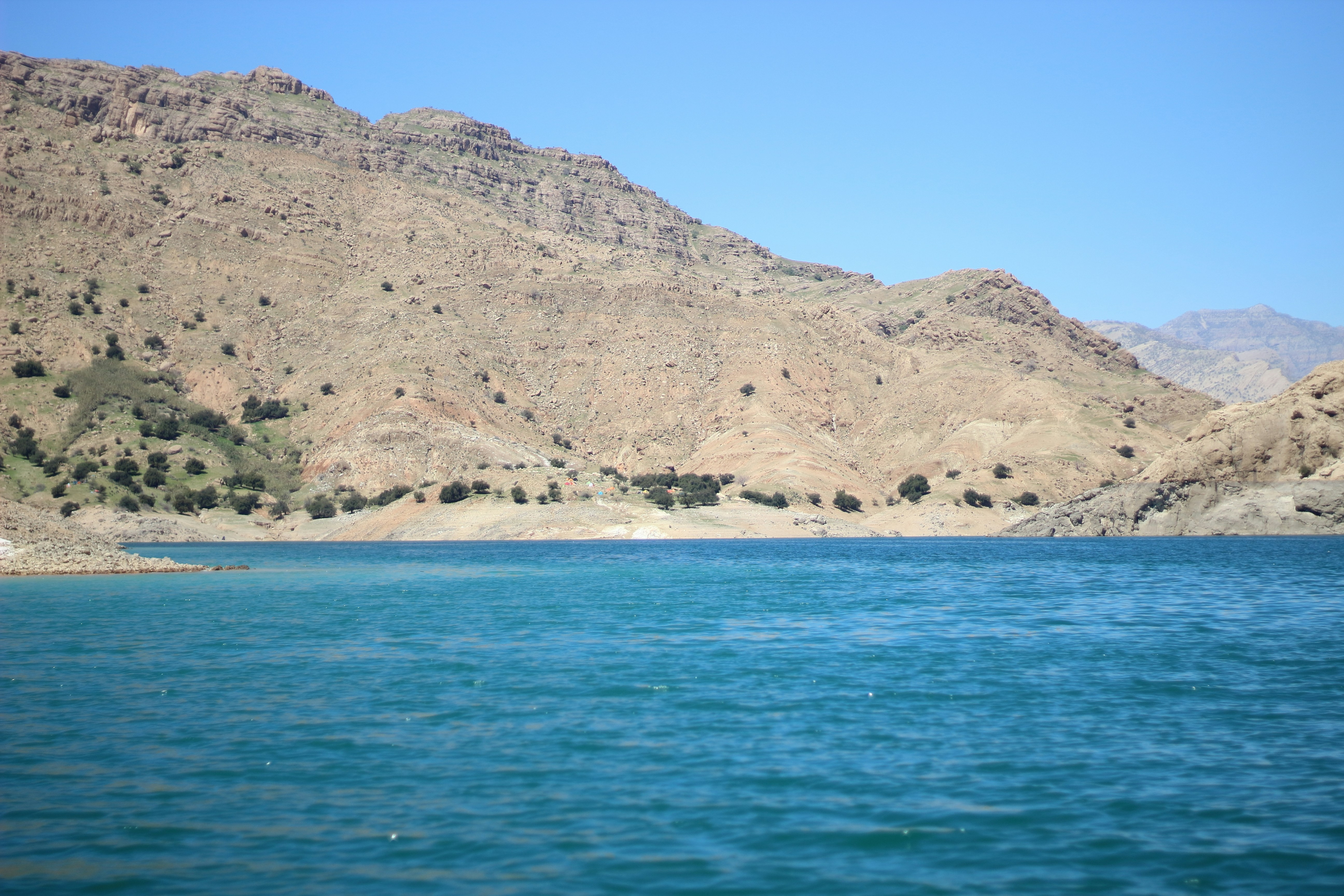 a body of water with mountains in the background