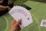 a person holding four of a kind of playing cards
