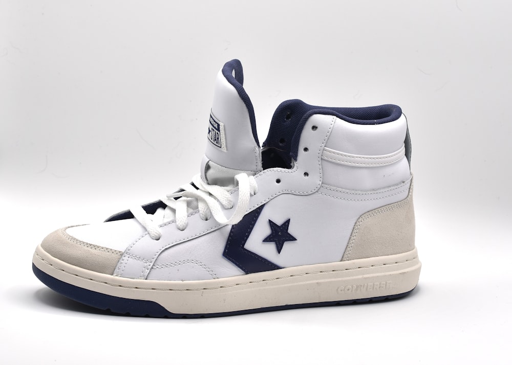 a pair of white and blue sneakers on a white background