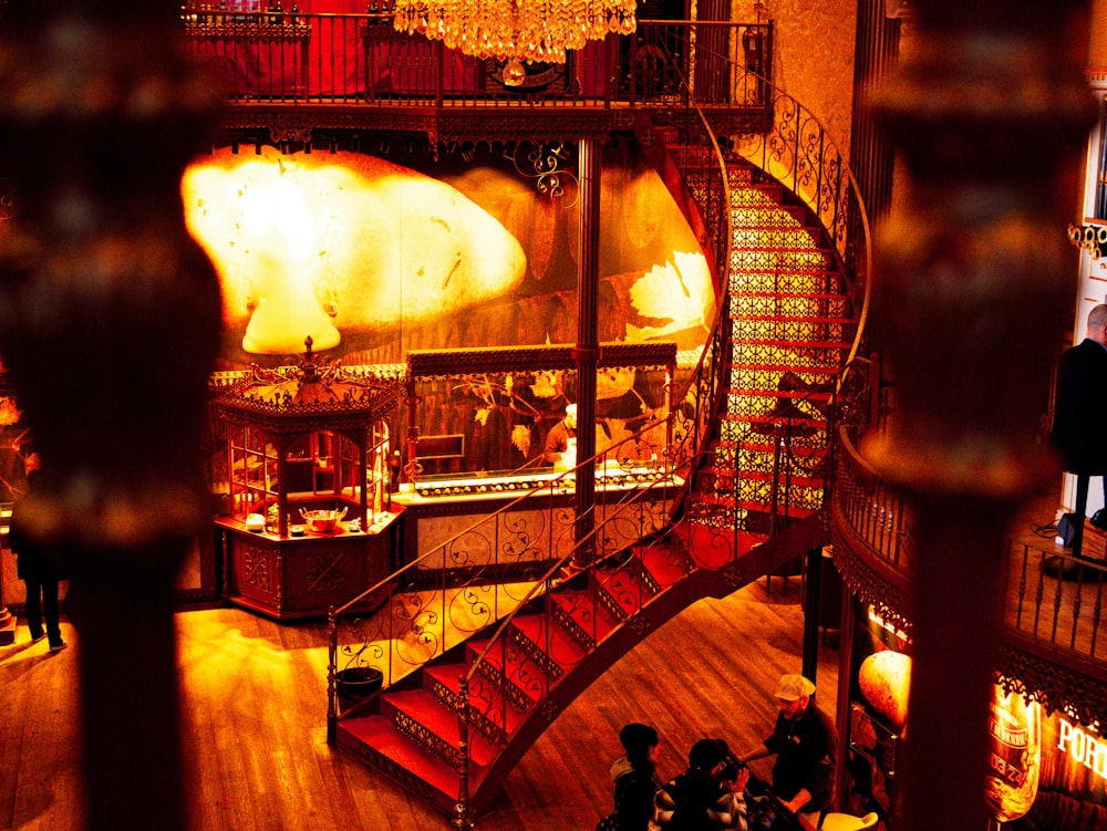 a large room with a spiral staircase and chandelier