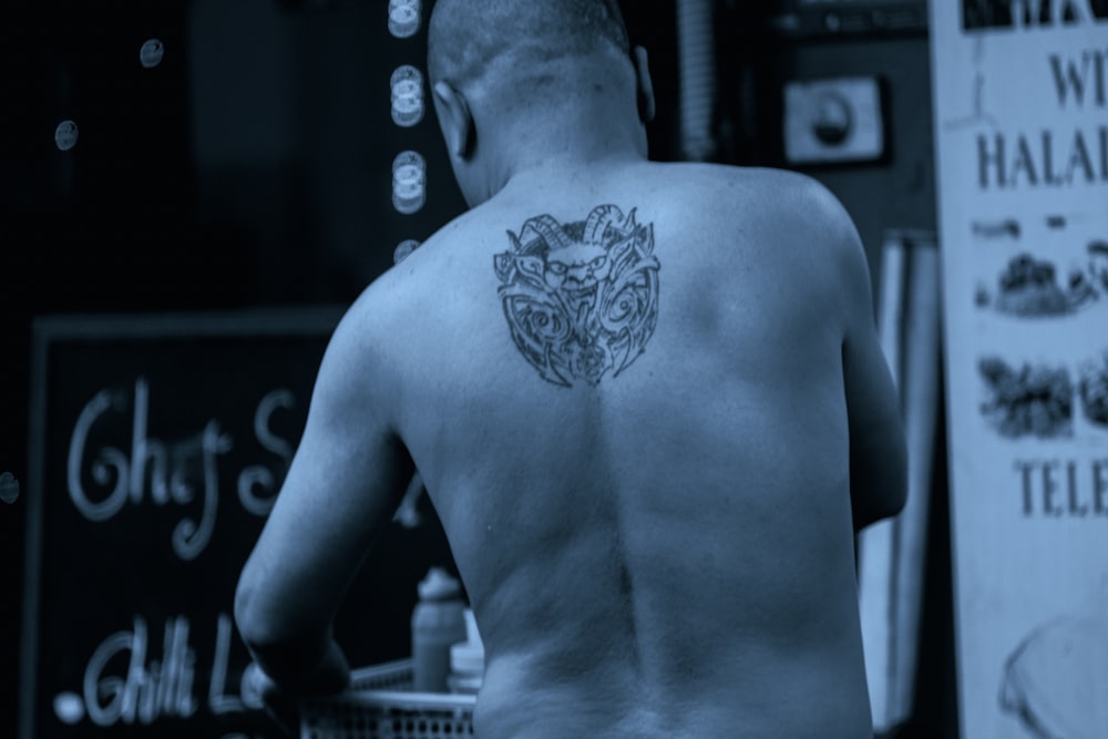 a man with a tiger tattoo on his back