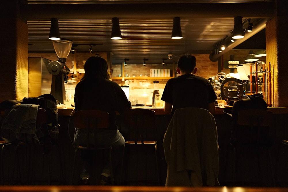 a couple of people that are standing in front of a bar