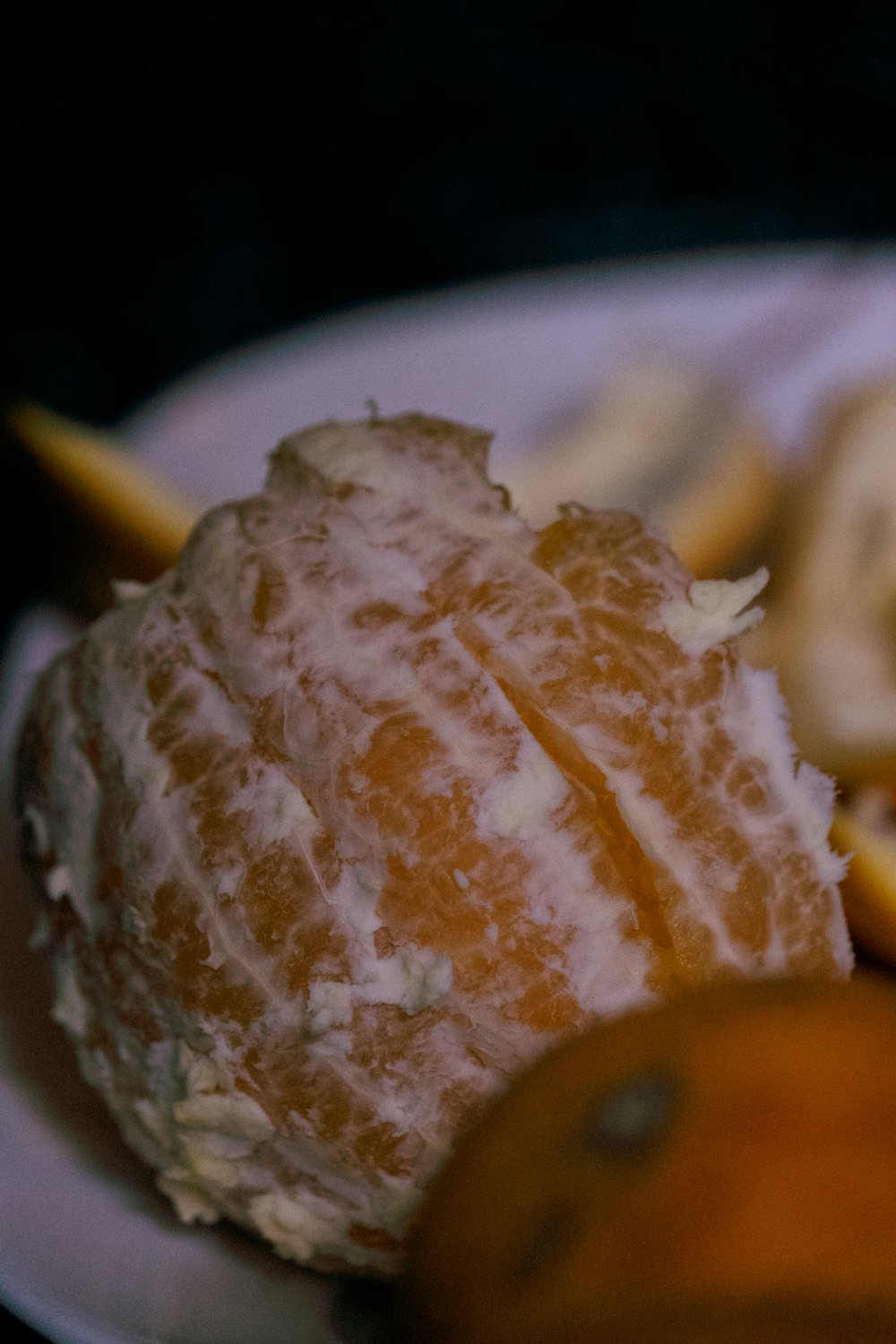 a white plate topped with sliced oranges and bread