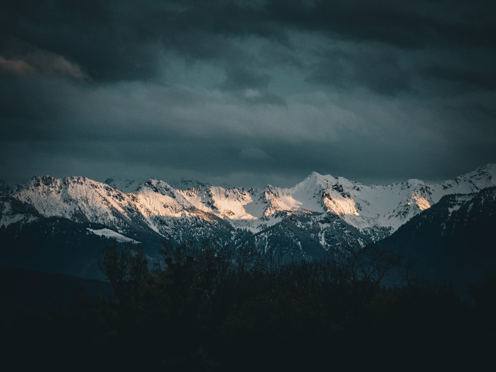 a view of a mountain range under a cloudy sky