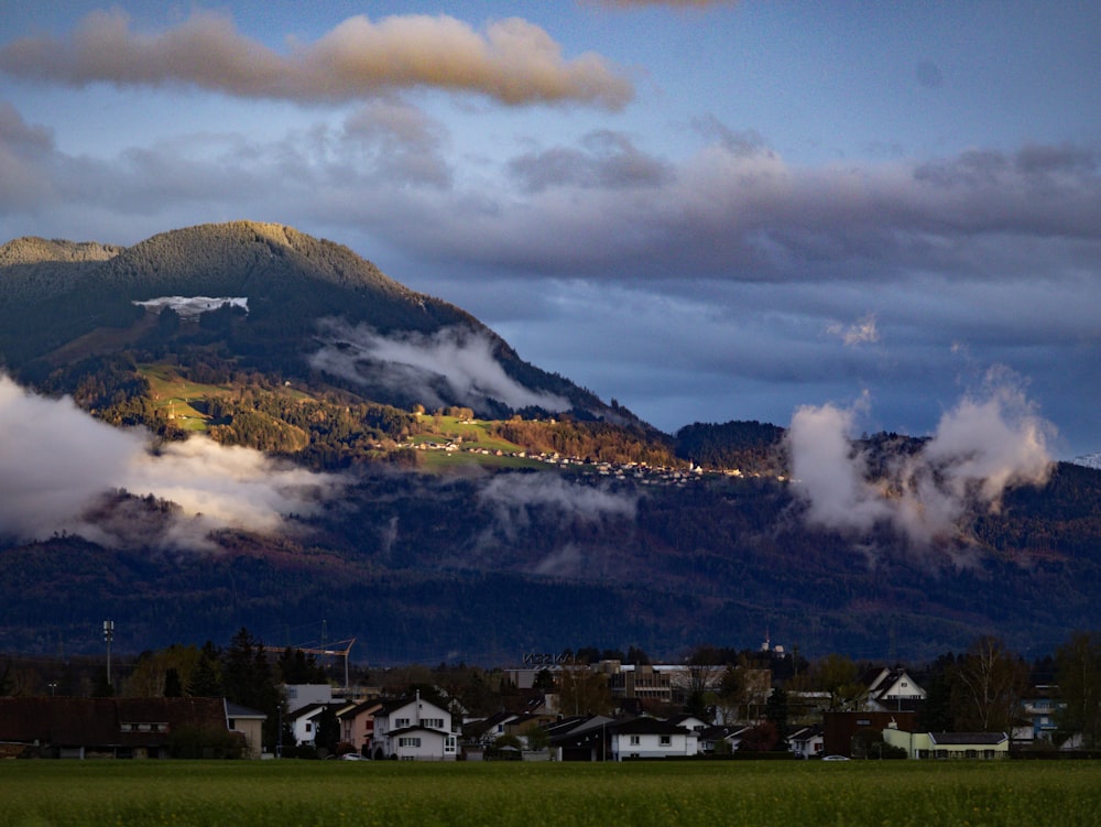 a view of a mountain range with houses in the foreground