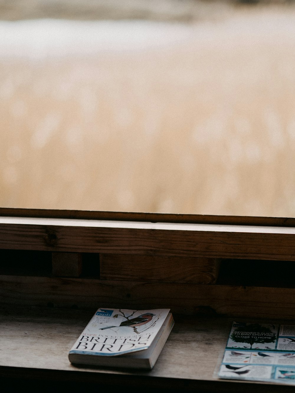 a book sitting on a window sill next to a window