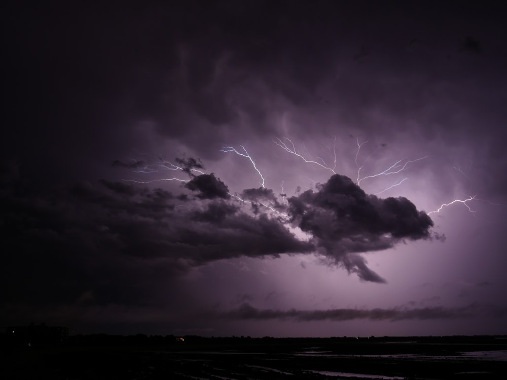 a lightning storm is seen over the ocean