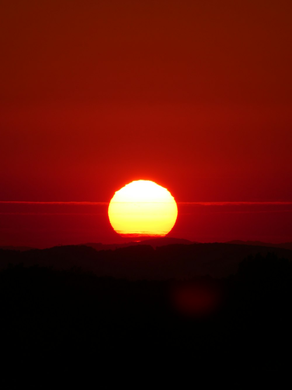 the sun is setting over a mountain range