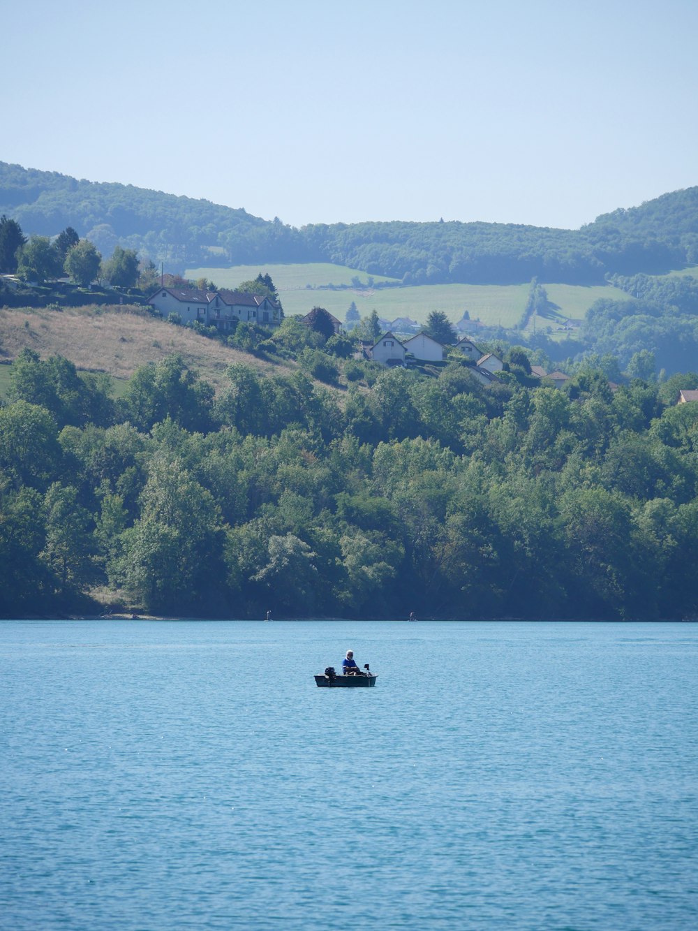 a person in a small boat on a large body of water