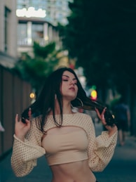 a woman with long hair standing on a street