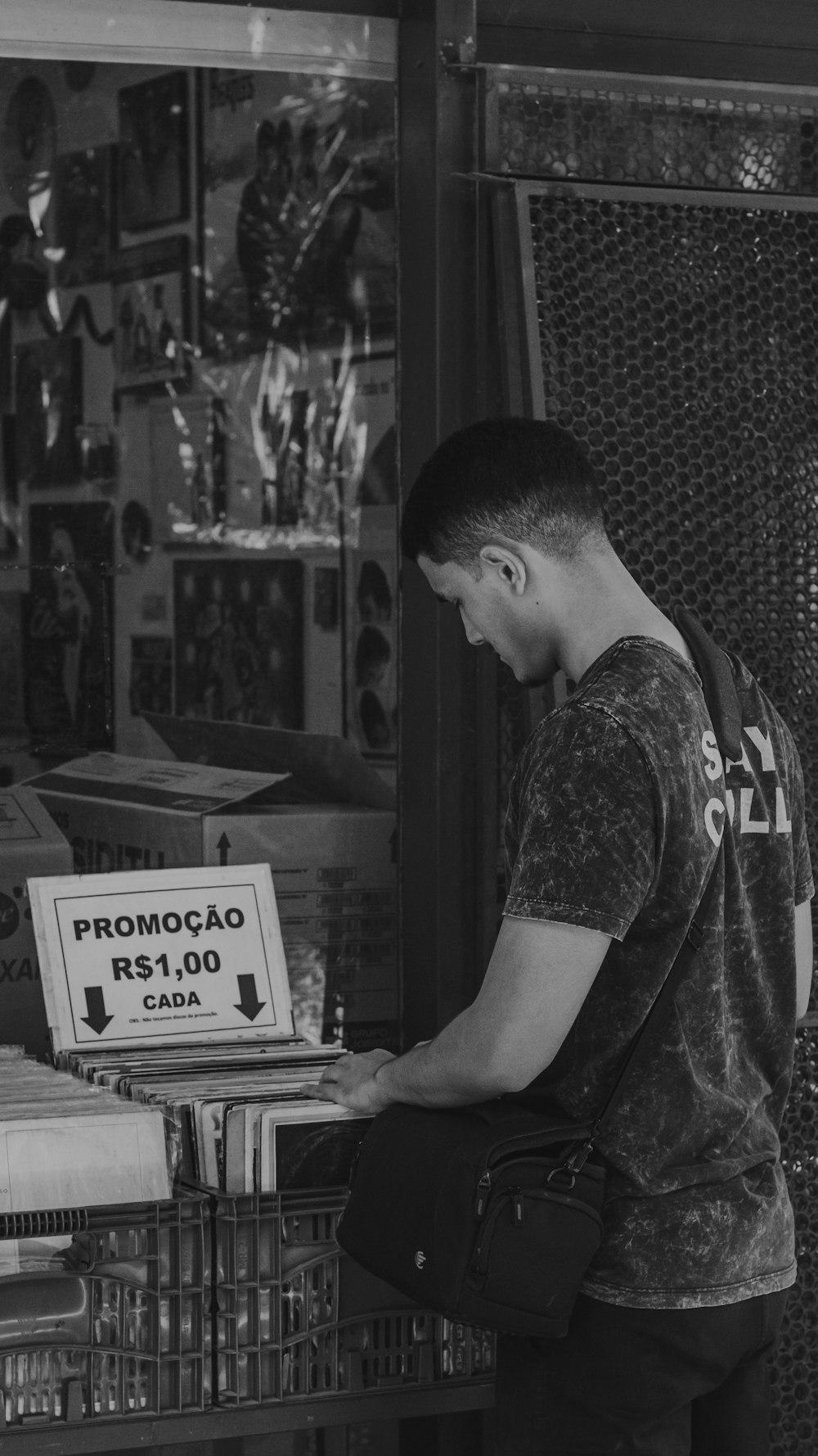 a man standing in front of a store holding a box