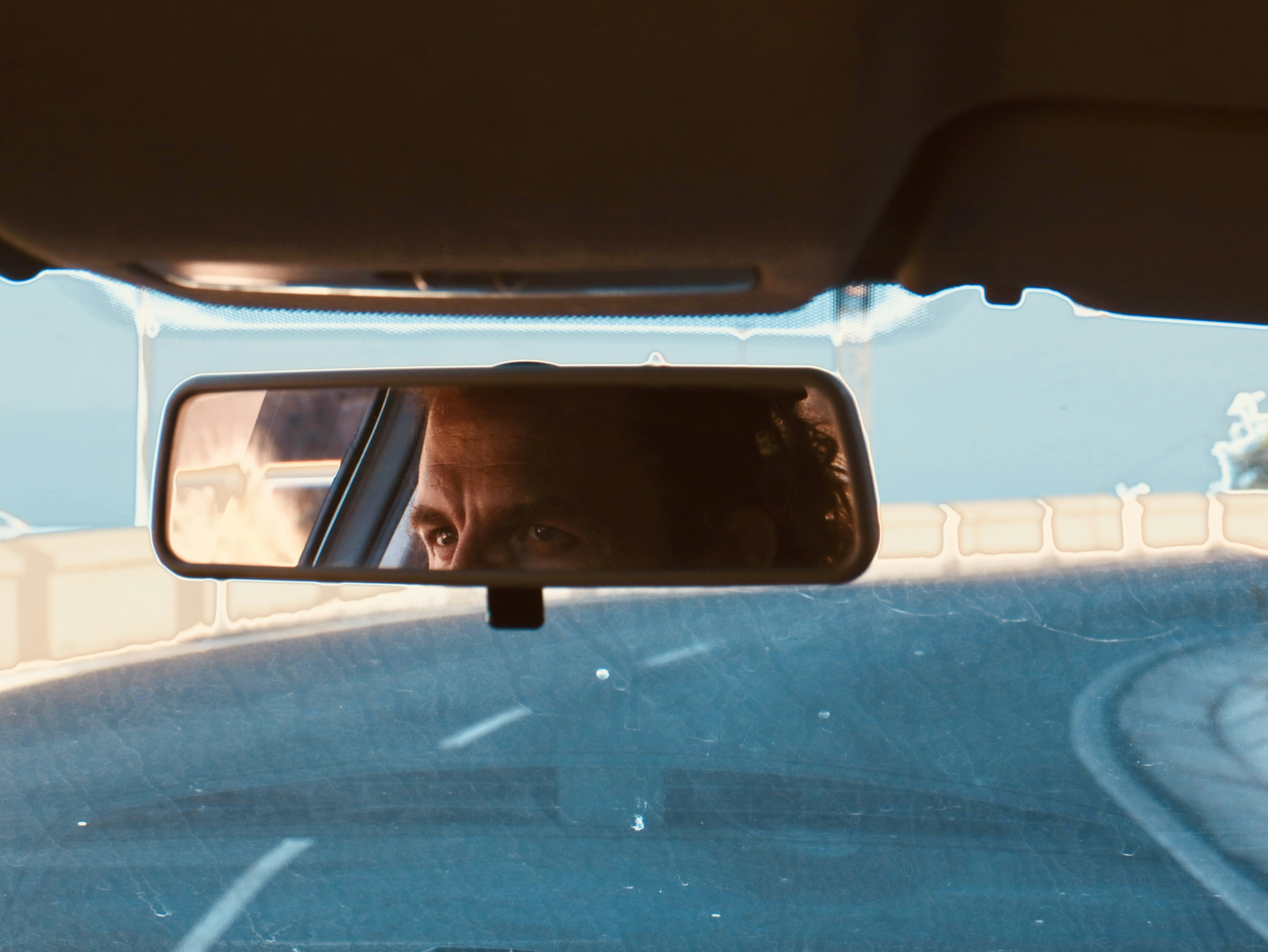 A man is seen in the rear view mirror of a car photo – Free Car Image ...
