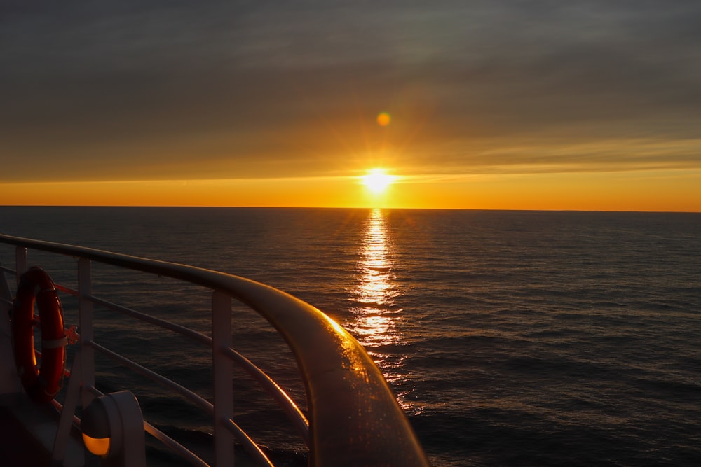 the sun is setting over the ocean on a cruise ship