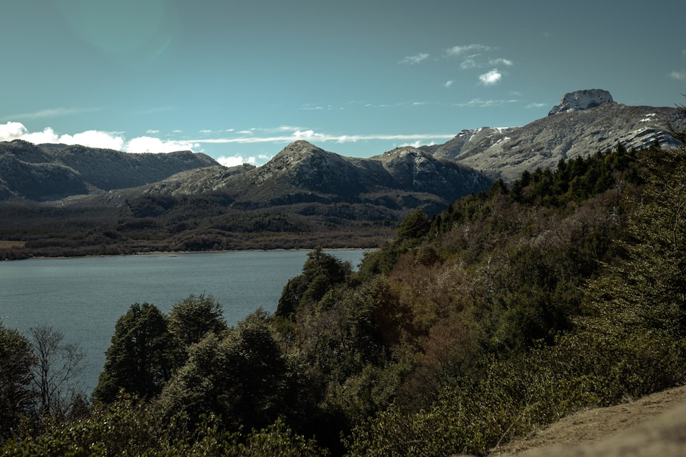 a view of a mountain range with a lake in the foreground