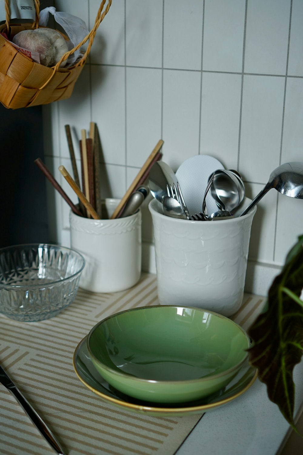 a kitchen counter with dishes and utensils on it