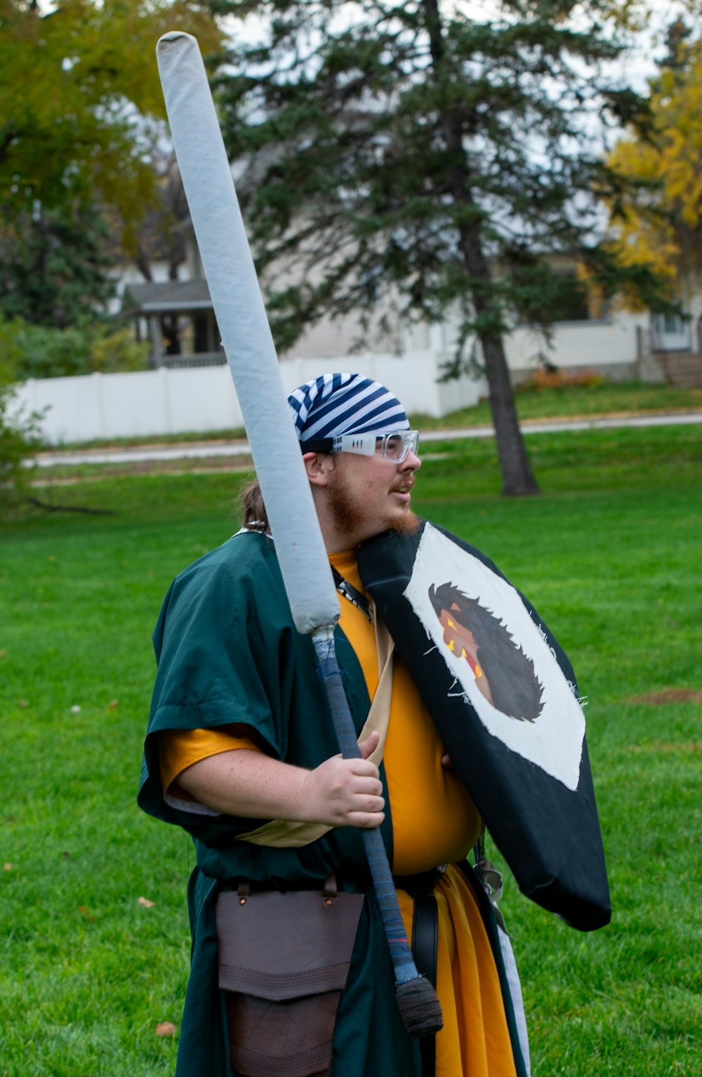 a man in a costume holding a sword and shield