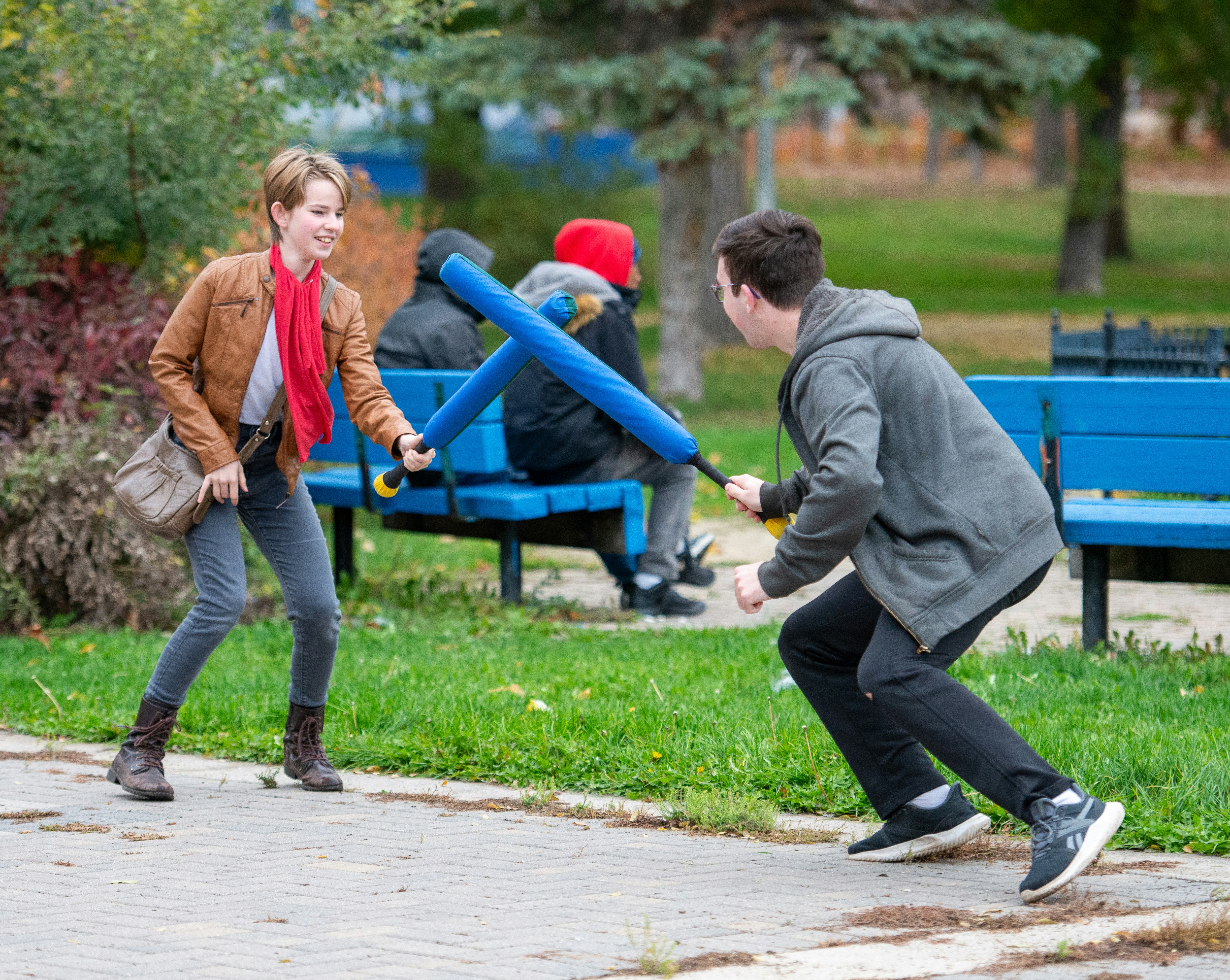 a man holding a giant blue object next to a little girl