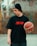 a young man holding a basketball on a basketball court